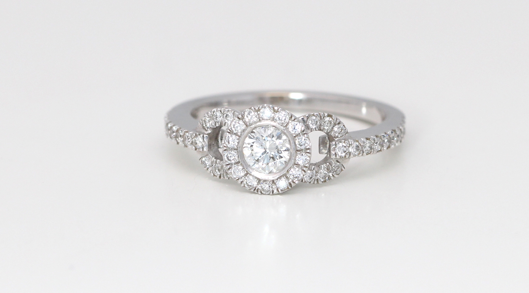 18k White Gold Round Cut Halo Diamond Shank Engagement Ring (0.55 Ct, F, VS1)